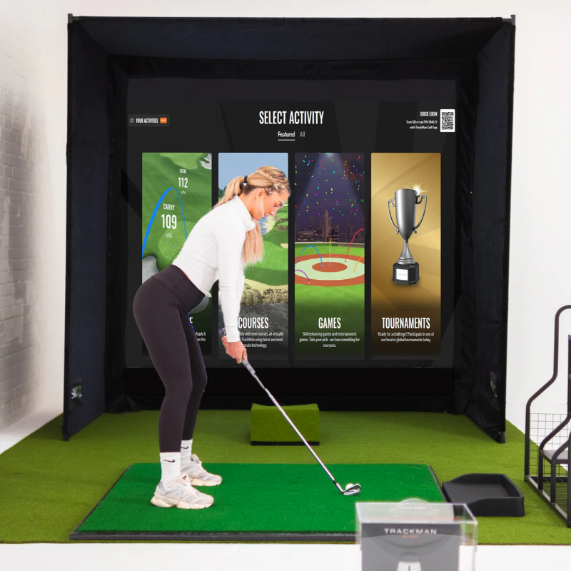 Person using a golf simulator with interactive screen displaying options